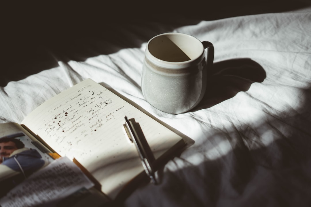 Warm morning light on a journaling desk with a notebook and pen
